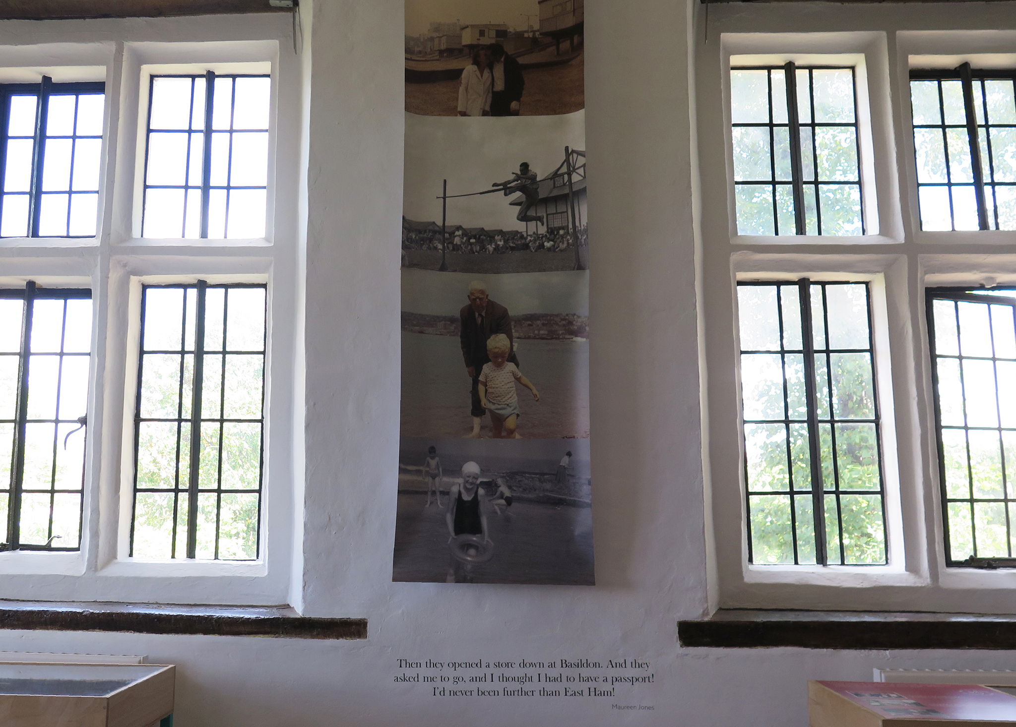 A large banner of historical photos hanging between two windows